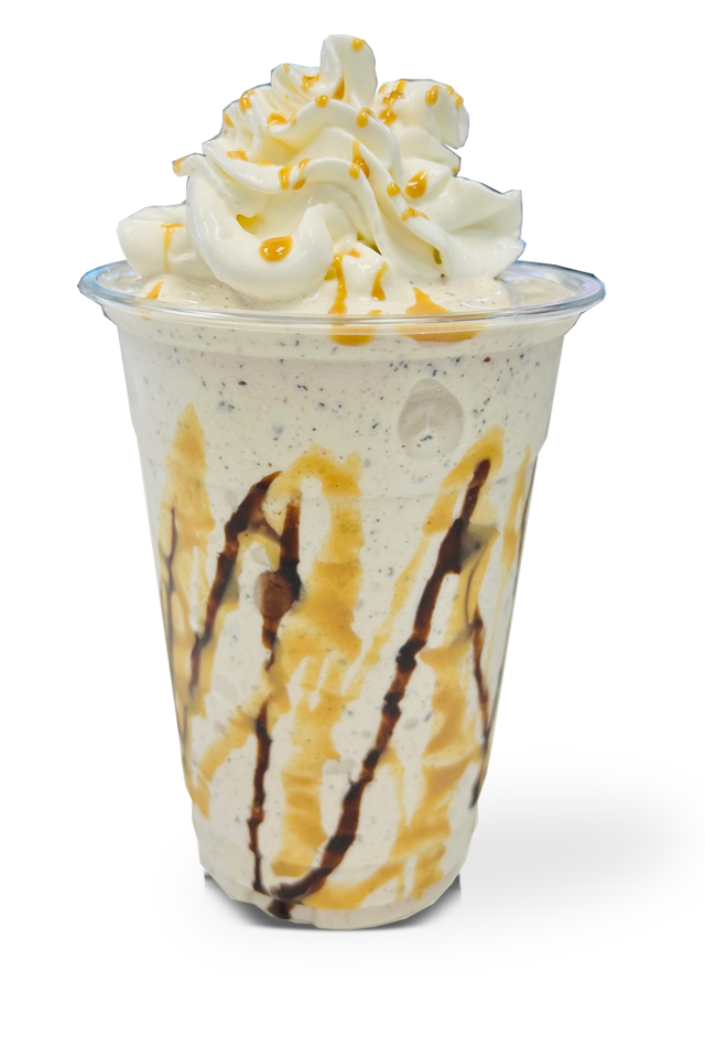 image of a milkshake with chocolate sauce, caramel sauce and whipped cream topped with caramel sauce drizzle